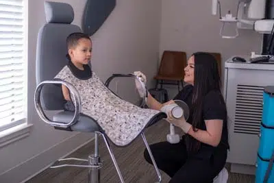 pediatric patient talking with one of Sycamore Smiles dental assistants