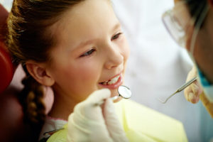 child getting her teeth examined at Sycamore Smiles in Fort Worth, TX