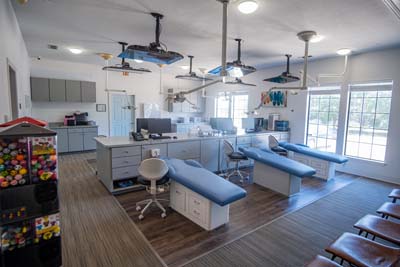 The dental treatment area with space for parents to sit at Sycamore Smiles in Fort Worth, TX
